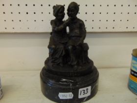 A bronze old couple on base