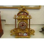 An Ormulu and porcelain mantle clock