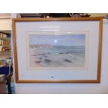 A framed and glazed watercolour of a seashore,