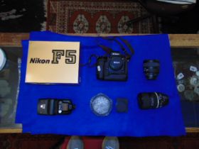 A Nikon F5 camera, lenses (3) and speed flash- full kit inc.