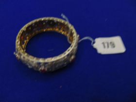 A White metal bangle, set with Rubies and Diamonds, approx.