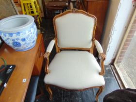 A carved and upholstered armchair