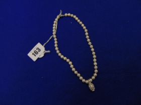 A Pearl necklace set with 18ct Diamond pendant and an 18ct Gold ball clasp