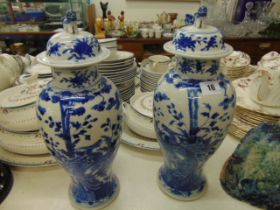 A pair of blue and white oriental lidded temple jars