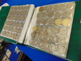 A qty of assorted coins in folder