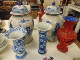 A pair of blue and white lidded vases,
