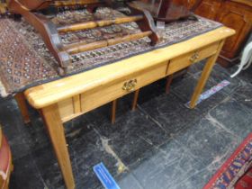 An Oak two drawer writing table