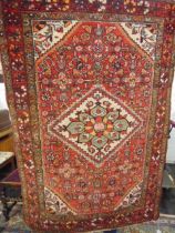 A red ground Persian rug