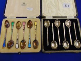 A boxed set of Silver and enamel spoon plus another