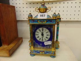 A brass and enamel mantle clock