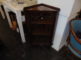 A glazed corner cabinet