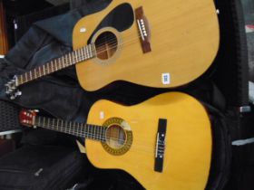 A Yamaha acoustic Guitar plus another