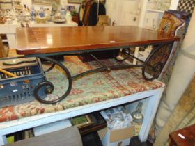 A Mahogany and wrought iron coffee table