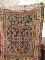 A brown ground Persian rug