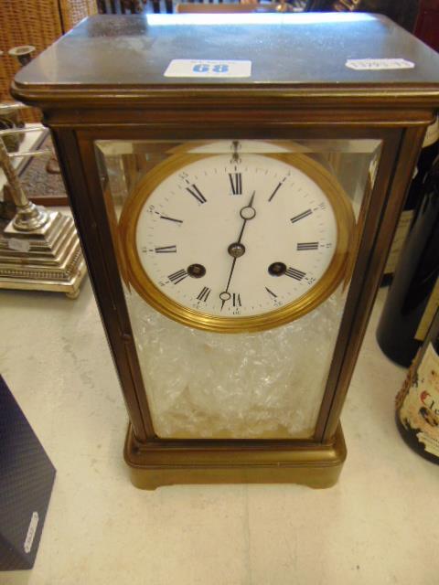 A brass and glass mantle clock