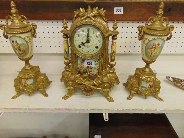 A gilt clock garniture set