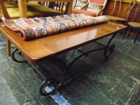 A Mahogany and wrought iron coffee table