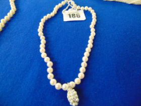 A Pearl necklace set with 18ct Diamond pendant and an 18ct Gold ball clasp