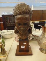 A bronze bust of a lady,