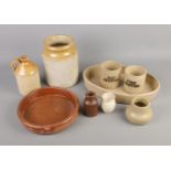 A quantity of stoneware including dripping pots, dishes and jars.