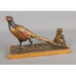 A cold painted spelter table lighter formed as a pheasant.