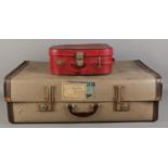 A large vintage suitcase, together with a red faux leather vanity case (empty).