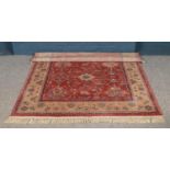 A Royal Keshan Agra red ground wool rug. 195cm x 140cm.