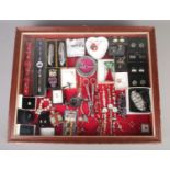 A table top bijouterie cabinet, containing contents of assorted costume jewellery. To include