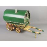 A painted wood Romany wagon model with detachable ladder.