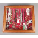 A large tabletop bijouterie cabinet containing an assortment of costume jewellery. To include