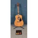 A Yamaha F310 acoustic six string guitar. Also includes guitar stand and step-by-step beginners