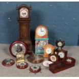 A quantity of mainly quartz clocks and barometers. To include miniature longcase/CD rack, H.