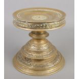 An antique brass tazza/stand. 17cm. Small hole in base.