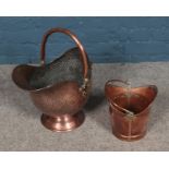 Two copper coal scuttles including example featuring hammered detailing.
