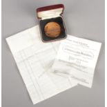 A cased limited edition bronze medal commemorating the final voyage of Cunard Queen Elizabeth, 1968.