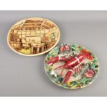 A Palissy style lobster plate along with other modelled plate depicting cottage interior.