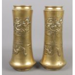 A large pair of brass vases decorated with dragons. 28cm.