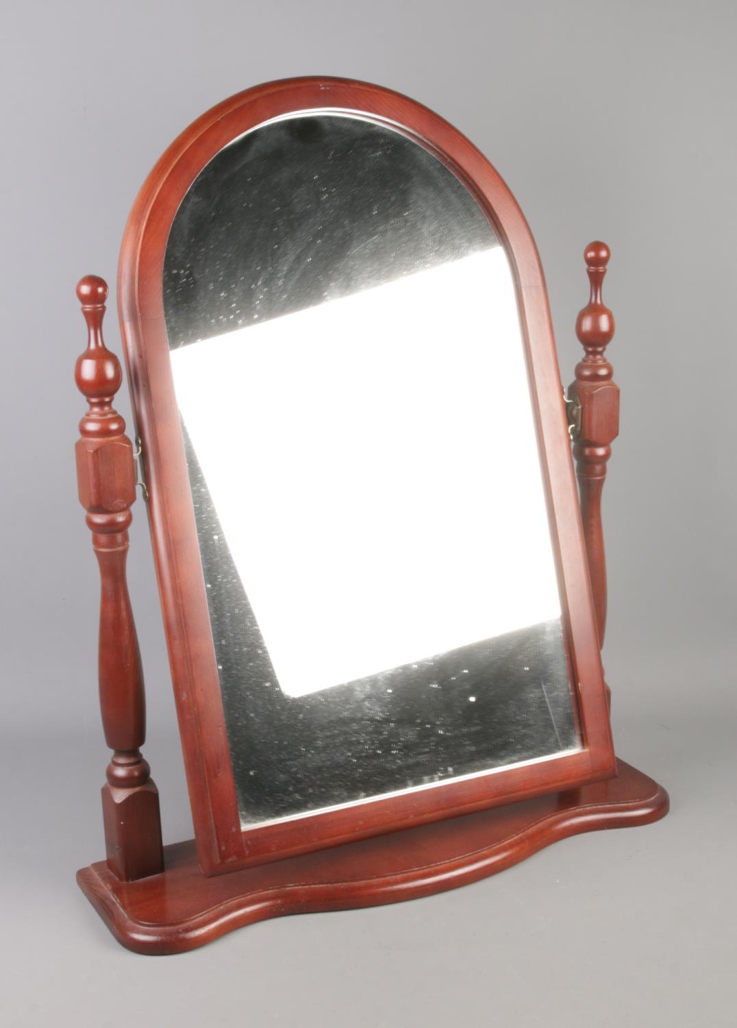 An adjustable toilet mirror with turned supports. Approx. dimensions 53cm x 65cm.