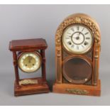 Two pendulum mantel clocks including one featuring Corinthian supports and one domed example with
