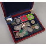 A coin case with contents of coins/medals. Includes DNA Double Helix Â£2 keyring, Cook Islands $1,