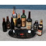 A box of assorted bottled alcohol and a Watney's pottery tray.