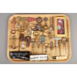 A tray of corkscrews and bottle openers. Including Cavatappi a Chiave, nude maiden, ships anchor,