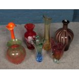 A quantity of coloured art glass vases.