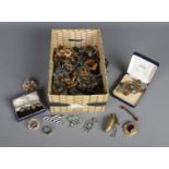 A box of costume jewellery. Including brass and enamel belt buckle, brooches, rings, clip on