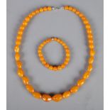 A butterscotch amber/copal graduated bead necklace along with matching bracelet.