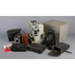 A Eumig P8 projector along with a box of photographic equipment. Includes Orion Werk plate camera,