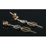 A pair of two-colour 9ct Gold pendant earrings. Total weight: 0.88g.