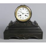 A black slate mantel clock, in drum shaped case on stepped rectangular plinth. With Roman Numeral