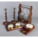 A collection of treen. Includes an oak two bottle tantalus, a pair of barley twist candlesticks, a