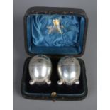 A cased pair of silver pepperettes. Assayed Sheffield 1891. 46g.